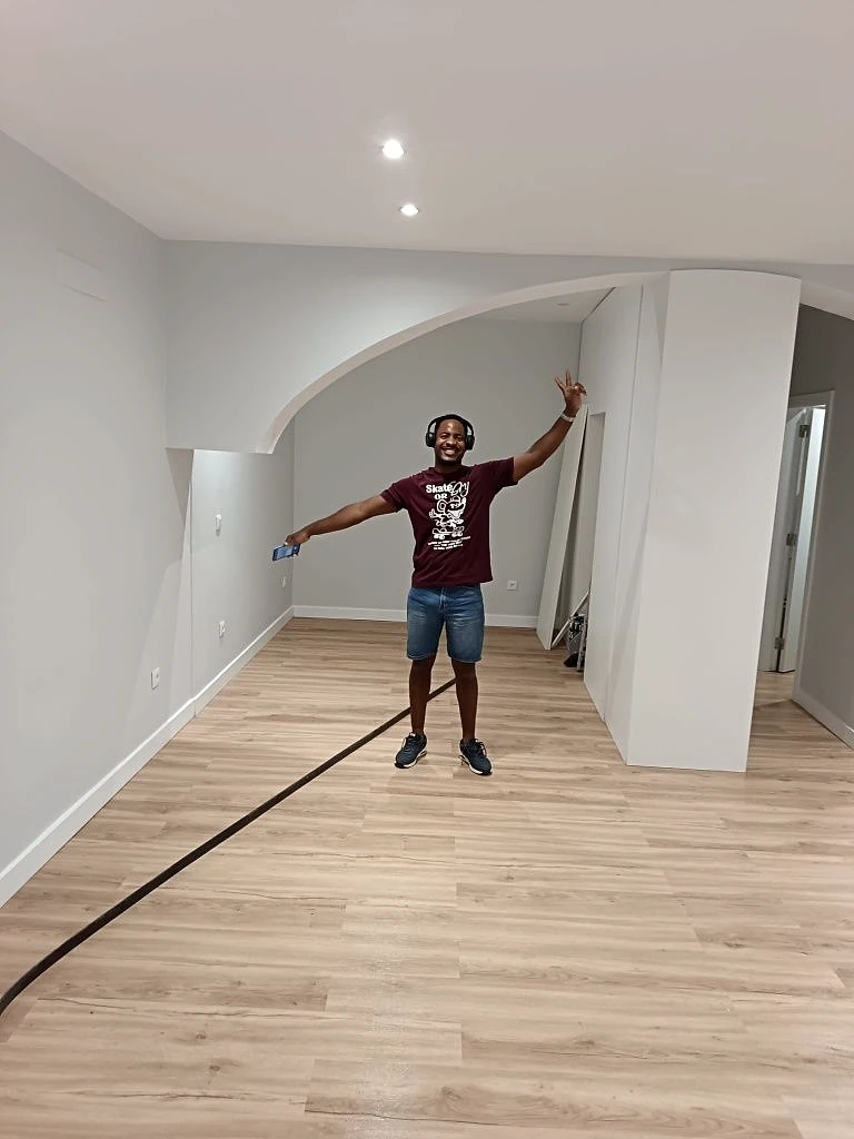 O Ilídio numa sala acabada, com arco e chão de madeira